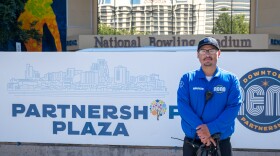 José Manzo-Rodríguez stands in front of the Partnership Plaza sign near the Downtown Reno Partnersh