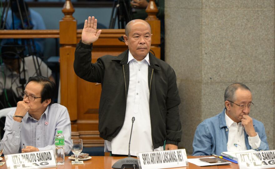 Retired police officer Arturo Lascañas takes his oath during a Senate hearing in Manila on March 6, 2017. The former police aide of Philippine President Rodrigo Duterte said he was part of a "death squad" that took part in hundreds of killings when Duterte was a city mayor.