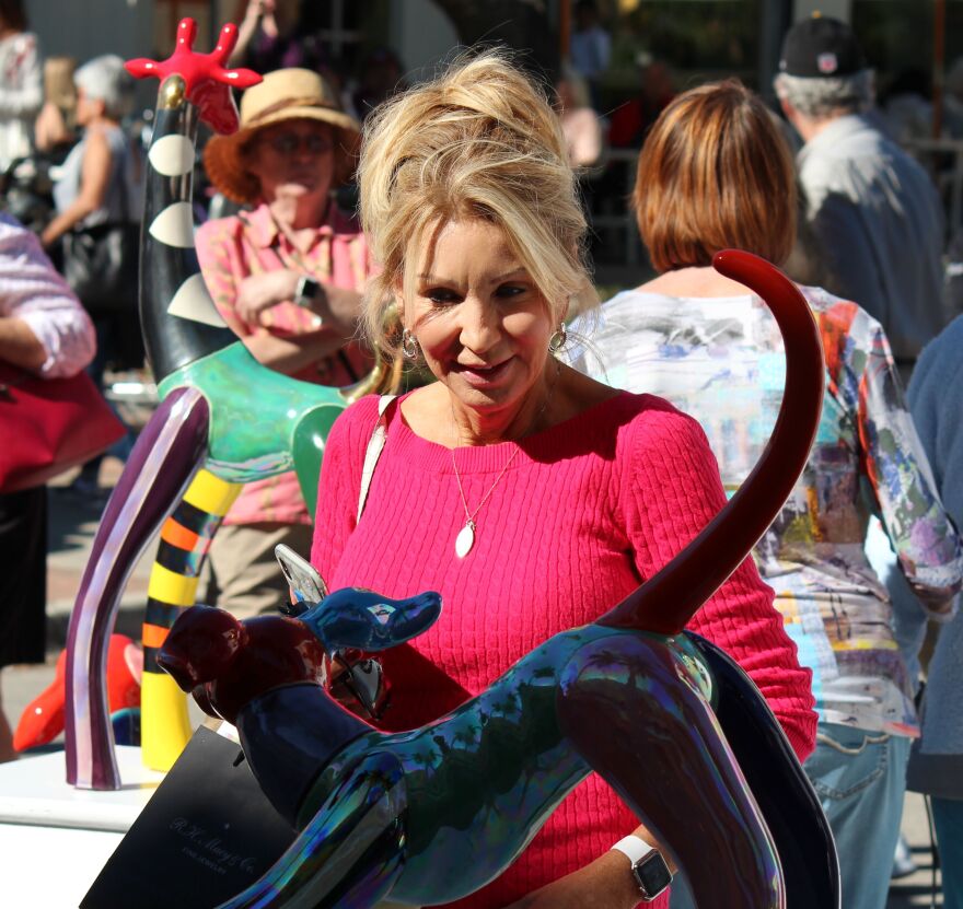 Guest examines a sculpture at the Naples New Year's Art Fair