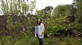 Maria Zavala stands in her garden, a testament to continuing living in Pescadero despite the threats of floods.