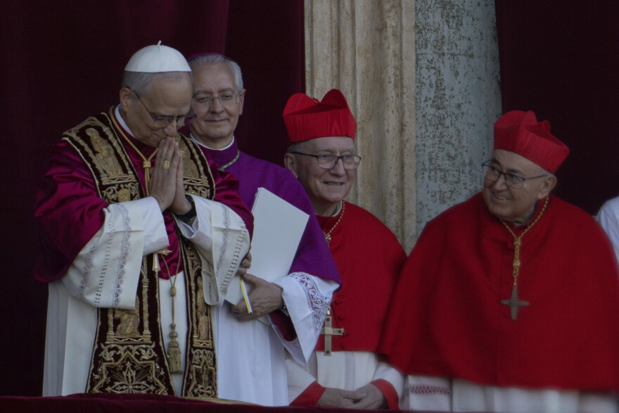 Newly elected Pope Leo XIV, left, formerly Cardinal Robert Francis Prevost, appears (left) at the Vatican shortly after his election as the 267th pontiff of the Roman Catholic Church, Thursday, May 8, 2025.