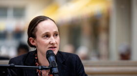 Seattle mayoral candidate Katie Wilson speaks into a microphone.