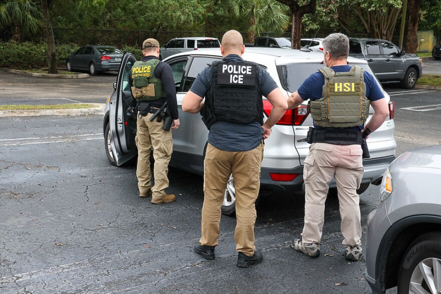 federal officials outside a car  
