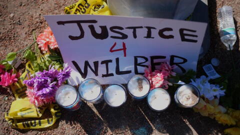 Flowers and candles are seen near the site where a Venezuelan man was shot in his vehicle by an ICE officer in Austin, Texas, Monday, Sept. 21, 2026. (Eric Gay/AP)