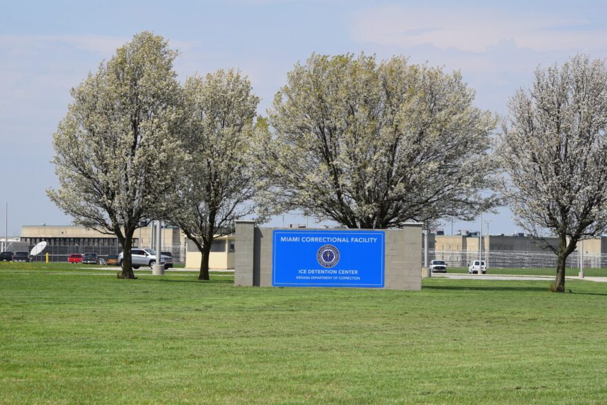 The sign outside of the Miami Correctional Facility. It says "MIAMI CORRECTIONAL FACILITY ICE DETENTION CENTER INDIANA DEPARTMENT OF CORRECTION" 