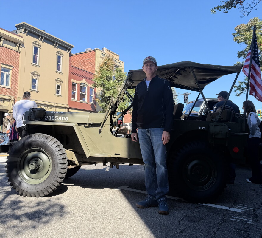 Joshua Clegg stands by his antique Jeep at Woosterfest. 