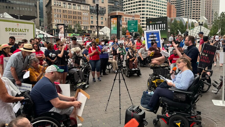 People rally outside of South Station in Boston on July 14, 2026.