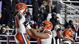 Syracuse's wide receiver Damien Alford and Matthew Bergeron (60) celbrate Alford's go-ahead touchdown during the second half of an NCAA college football game against Boston College, Saturday, Nov. 26, 2022, in Boston. (AP Photo/Mark Stockwell)
