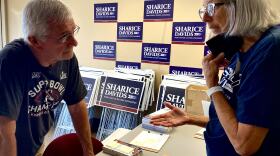 Volunteer canvasser Steve Gilley takes pointers from Davids volunteer Nancy Pence