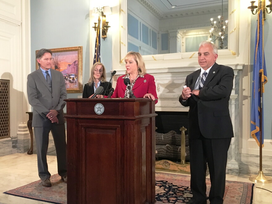 Gov. Mary Fallin announces new cabinet appointments with Mike Hunter, Jennifer Chance, and Chris Benge during a news conference Monday.