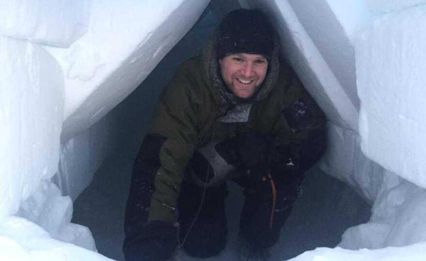 Sgt. Jess Evans — the course's lead instructor — in a "fighter trench" shelter built from snow. Jan. 30, 2019. (Photo by Ravenna Koenig/Alaska's Energy Desk)