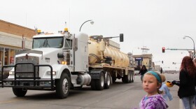 The oil industry stages events like this energy festival parade in downtown Williston in an effort to maintain good relations with the community. Industry rigs and trucks of every description roar by as drivers throw candy to the kids.