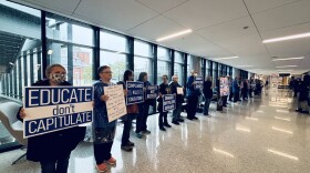 Protesters with Peaceful Bluegrass Resistance line a back hallway of UK's Gatton Student Center for a peaceful demonstration on April 25, 2025.
