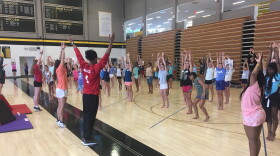 Girls work on gymnastics skills at Camp WIN this week in Kansas City, Missouri. The national gymnastics championships will be held at Sprint Center later this summer.