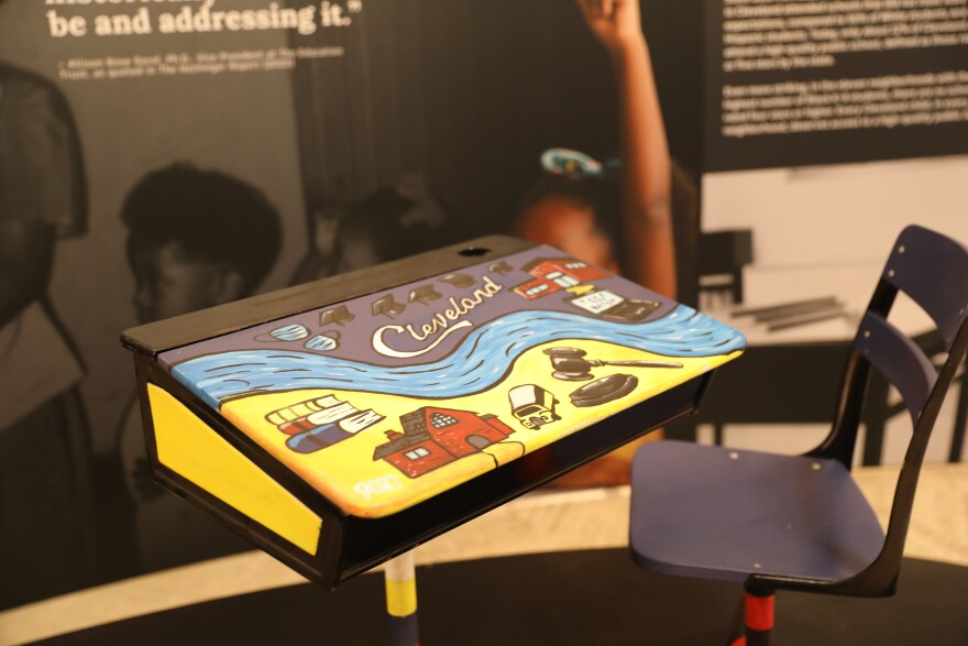 A desk painted by a Cleveland schools student bookends the Relay Cleveland exhibition.