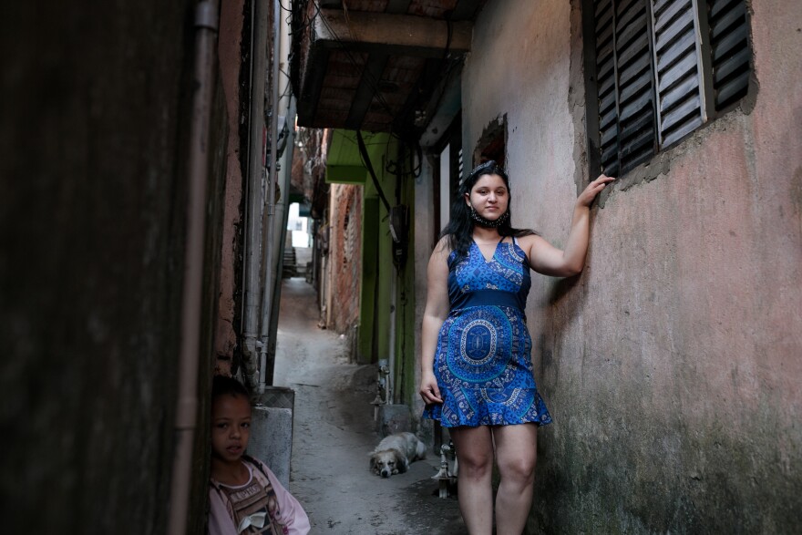 Jessica Fernandes de Andrade outside her house in a favela in São Paulo, Brazil. She contracted the novel coronavirus and has recovered but still suffers from fatigue, which has kept her from working.
