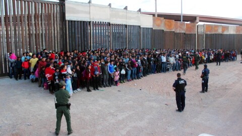 President Trump has announced plans to impose escalating tariffs on goods imported from Mexico in an attempt to stop migrants from entering the U.S. over the southern border. Shown here are migrants at the border in El Paso, Texas, on Wednesday.