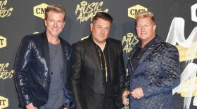 FILE - In this June 6, 2018, file photo, from left, Joe Don Rooney, Jay DeMarcus, and Gary LeVox, of Rascal Flatts, arrive at the CMT Music Awards at the Bridgestone Arena on Wednesday,, in Nashville, Tenn. The country group will bless the broken road this year on their farewell tour on their 20th anniversary together. The group announced Tuesday, Jan. 7, 2020, that they have no future plans for the band after the tour that begins in June and runs through October.
