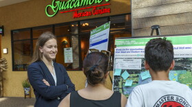 Sarabrent McCoy, an urban planner with Stantec’s Urban Places, talks with visitors to the Trumbull Mall about its future uses.
