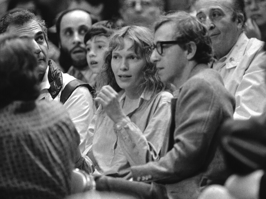 Mia Farrow and Woody Allen watch a basketball game in 1983. Dylan Farrow's statement alleging that Allen abused her was published online by a <em>New York Times</em> columnist.