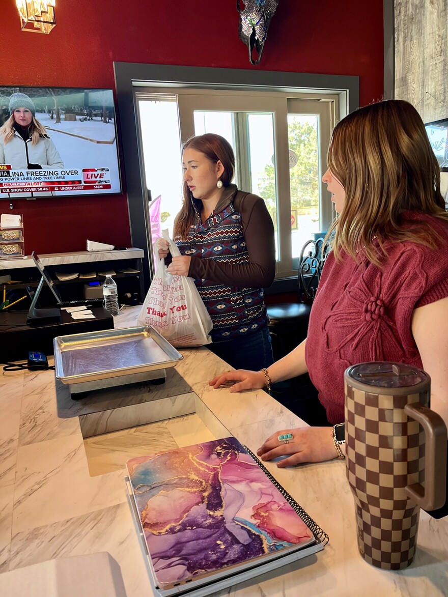 Lamont and Jennifer’s daughters hand out sacks of free dog bones at Montana Prime Meats