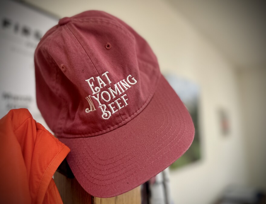 A red hat that says, ‘Eat Wyoming Beef,’ hangs from a coat rack.