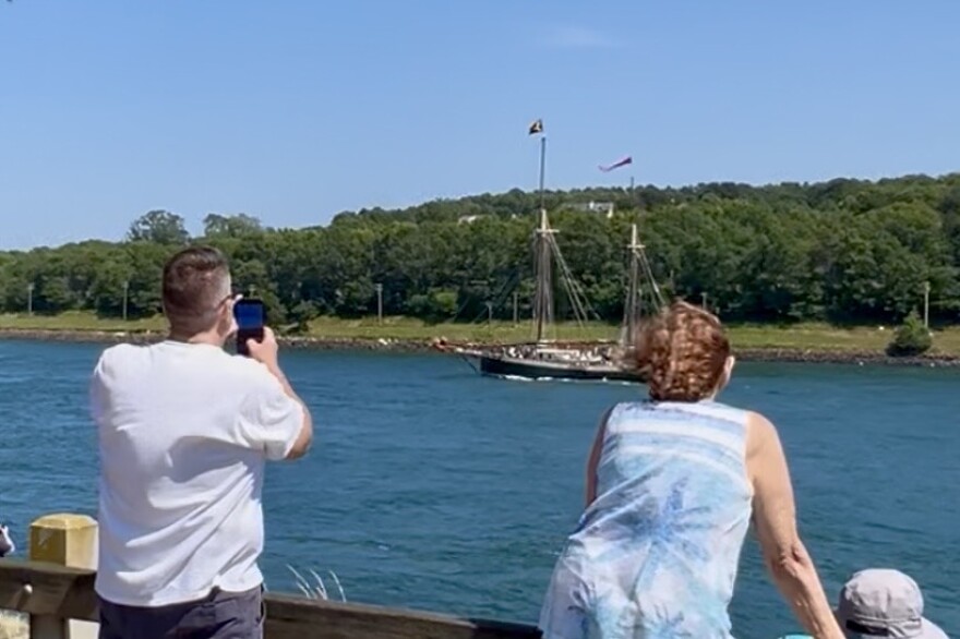 Spectators watch from along the Cape Cod Canal as the 130-foot tall ship Angelique makes it way through the canal on its way to Boston for Sail250, July 9, 2026.