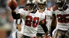  Ronde Barber holding a football with one hand in celebration