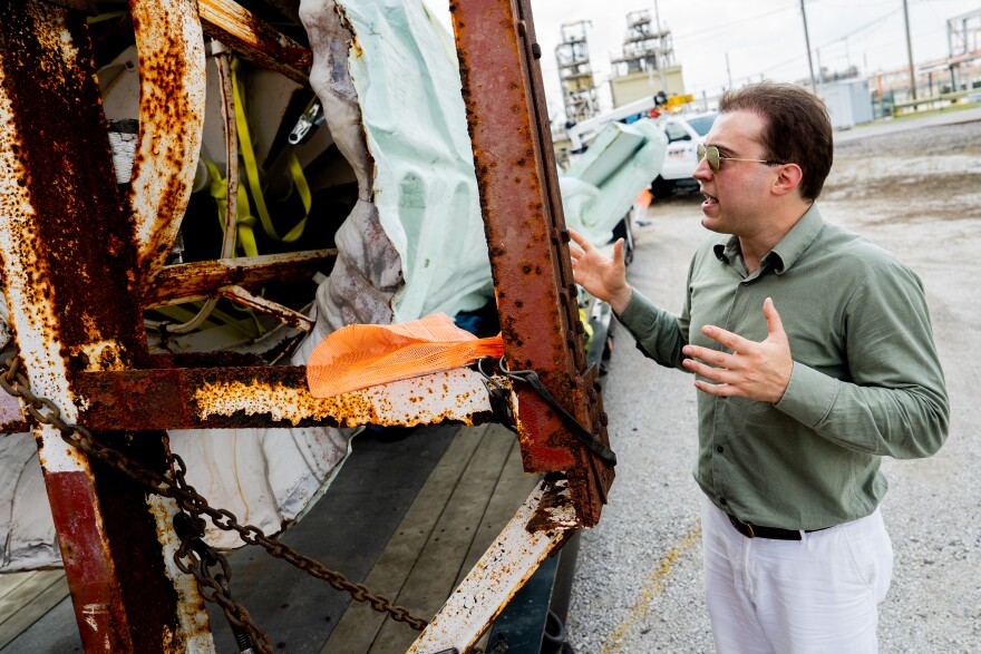 Frank Trampe looks at rusted out frame to a Statue of Liberty replica