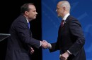 Utah Republican Sen. Mike Lee, left, and his independent challenger Evan McMullin shake hands following their televised debate, Monday, Oct. 17, 2022, in Orem, Utah, three weeks before Election Day. The debate will be the only time the candidates appear together in the lead-up to next month's midterm elections.