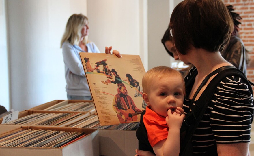 Syndey Downing, 34, and her 17-month-old son Max dig through crates, hoping to expand their record collection.