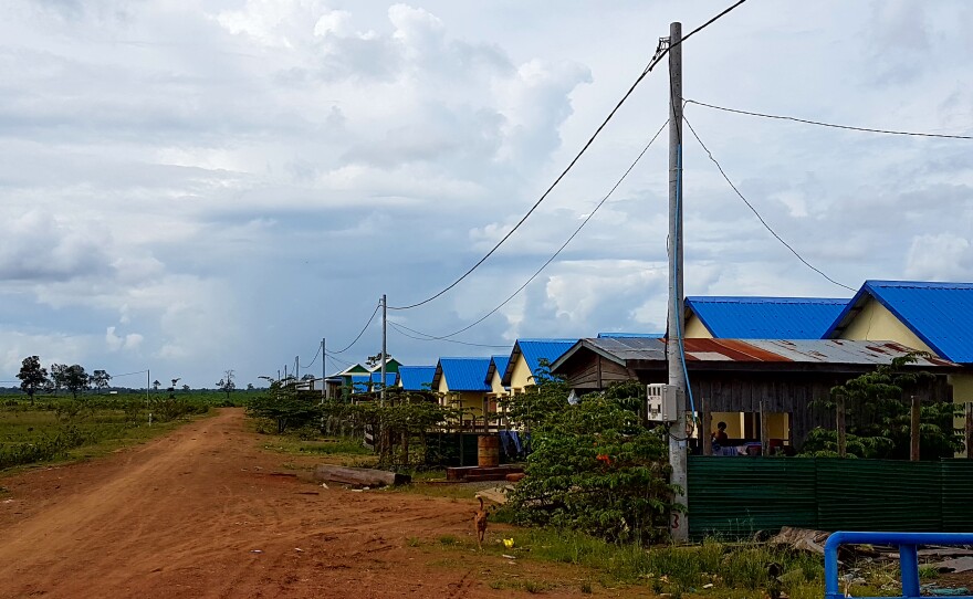 New housing has been built for villagers who agreed to be resettled from Kbal Romeas. The new village is far from the river, so they have to pay for food and water now. Some complain they have not been compensated as they were promised.