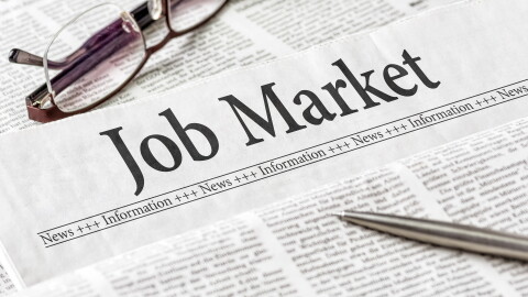 A newspaper with the headline Job Market