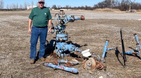 Jeff McCaskill, director of the University of Oklahoma's Tuttle geothermal project, stands next to a retired well the team is converting for geothermal use.