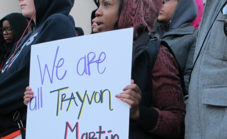A student holds a sign at a Hoodies for Trayvon rally Monday evening at Syracuse University.