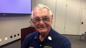 Older man with glasses wearing dark blue Phoenix Police Museum shirt