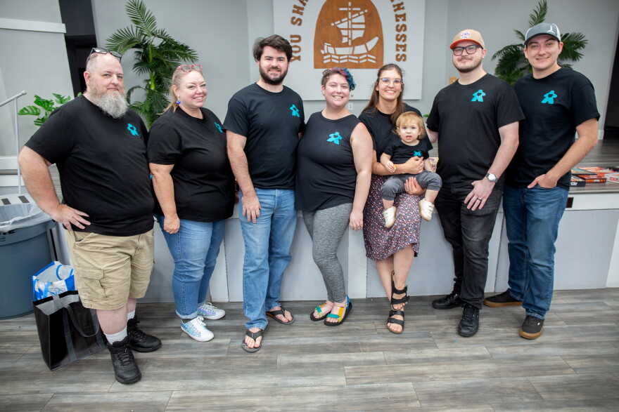 Board Game Therapy's Board of Directors from left to right: Matthew Nimmo, Kathy Dickson, Ryan Merrill, Shayna Gurvitz, Olivia Gwaltney, Liam Gwaltney (baby), Matt Gwaltney, Dylan Suttle.