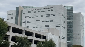multi story white building and garage, that says Texas Woman's University