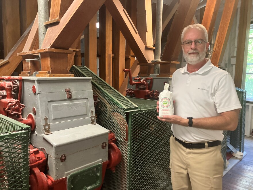 James Elkins, general manager at Big Spring Mill, holds a bag of freshly ground cornmeal.