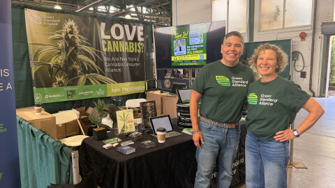 Herb Barbot, left, and Linda Baldwin stand at the Green Standard Alliance booth at the New York State Fair.