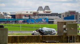 An unidentified person sleeps on the Serpentine Wall at Sawyer Point.