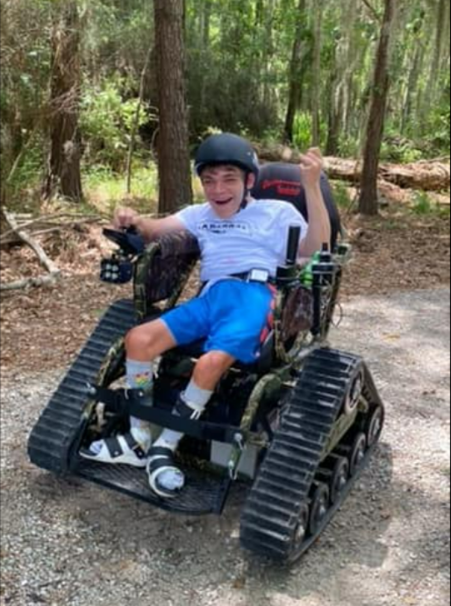 Elijah Clement riding the all-terrain wheelchair at Fontainebleau State Park