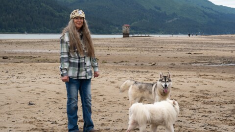 woman with dogs on beach