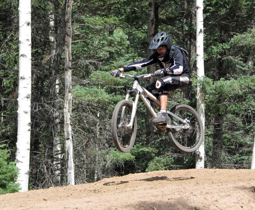 In an Aug. 21, 2010, photo, Andy Nagle of Albuquerque, N.M., rides a jump line at the bike park in Angel Fire, N.M.