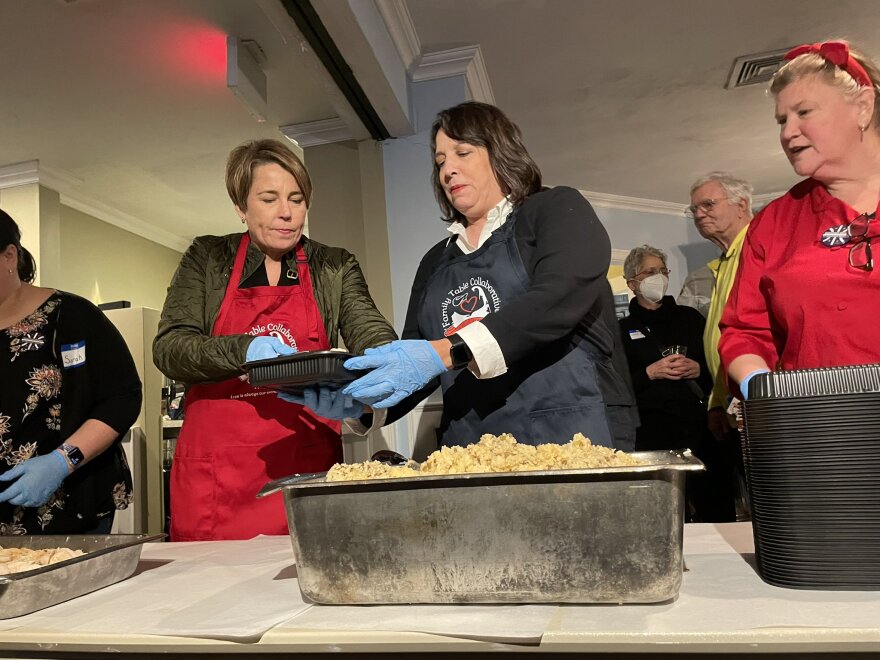 Governor-elect Maura Healey and Lieutenant Governor-elect Kim Driscoll package meals with guidance from Jeni Wheeler, co-founder of Family Table Collaborative.