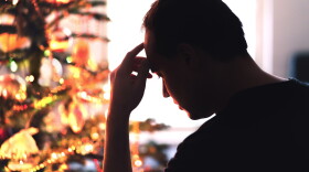 Sad on Christmas. Unhappy, lonely or tired man with with stress, grief or depression. Family fight, loneliness, frustration or money problem on Xmas. Sick person with flu, pain and headache on holiday