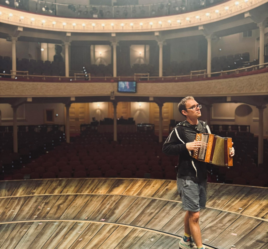 Rock Island native Mason Moss with an accordion on the Ford's Theatre stage, where he's music directing "Come From Away" through Oct. 25, 2026.