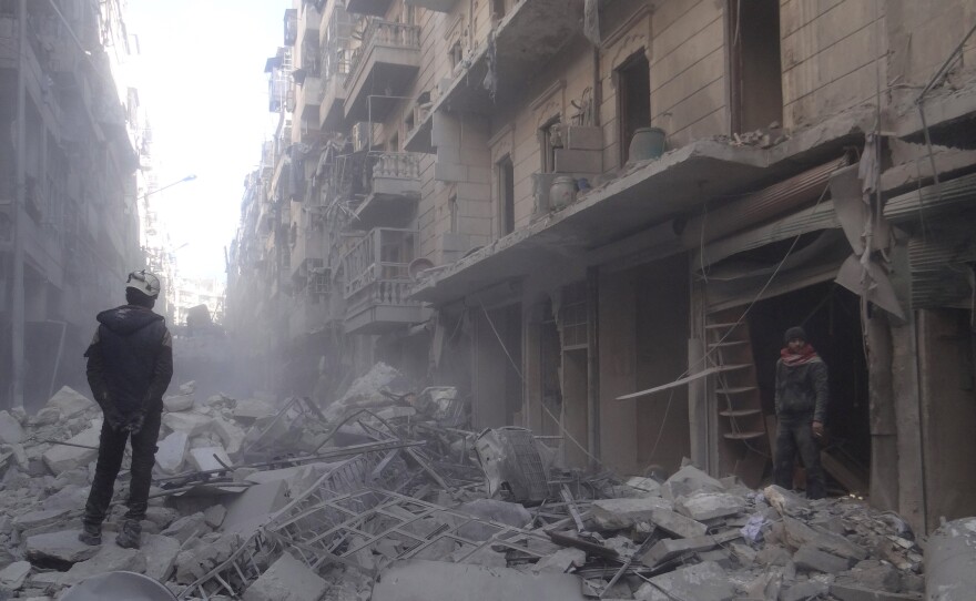 A man stands in the debris of a building Friday after an airstrike allegedly carried out by the Russian miliary in a part of Aleppo controlled by the Syrian opposition.