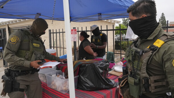 A woman is detained by U.S. Border Patrol agents outside a Home Depot Friday, Aug. 15, 2025, in Los Angeles. (AP Photo/Gregory Bull)