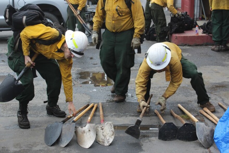 Firefighters with the private contracting outfit Inbound LLC stack shovels and other hand tools at the company’s headquarters in Oakridge, Oregon. CREDIT: TONY SCHICK
